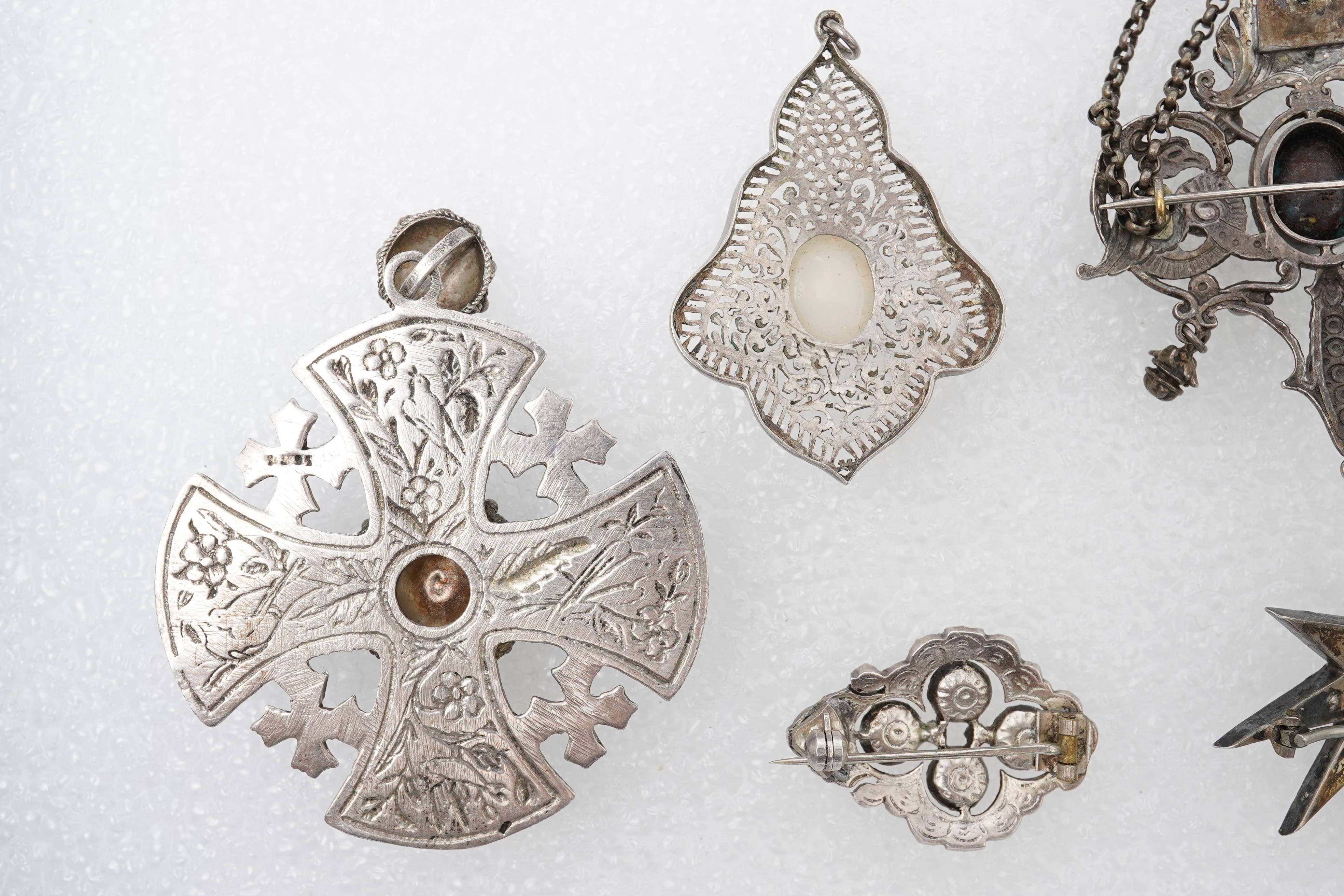 A group of jewels, comprising: a late 19th century and later Renaissance revival-style pendant set with an oval turquoise cabochon, circular-cut garnets and circular-cut green chalcedony, mounted in silver, length 6cm, s